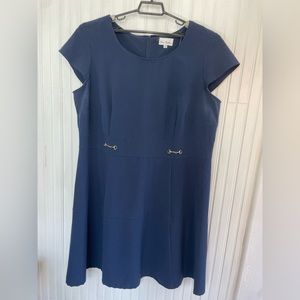 Navy short sleeve dress with gold metal embellishments.